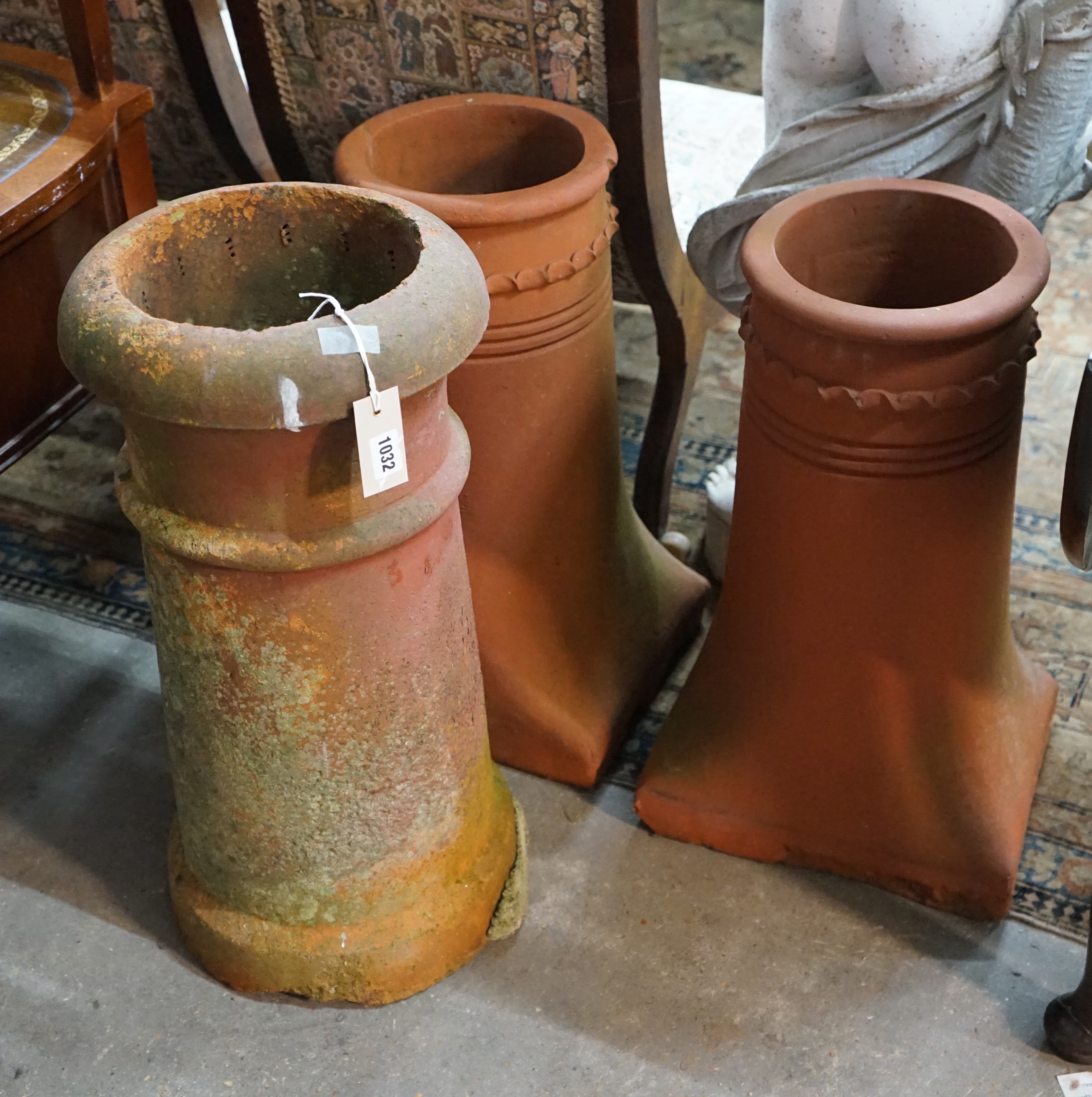Three terracotta chimney pots, largest height 62cm